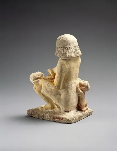 The back of the painted limestone statue of a woman nursing two small children