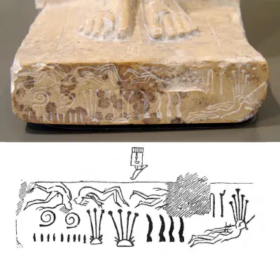 The base of the seated statue of Khasekhemwy. Carved around the base are the bodies of defeated northern enemies, accompanied by a plant mot