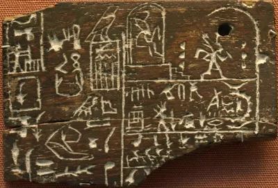 Ebony oil label fragment recording a royal year inscription of King Den. Early Dynastic Period, showing scenes of the Sed festival alongside